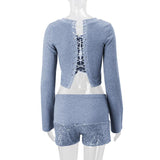 Long sleeve hollow out lace up textured round neck top