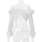 Blusa de manga larga con botones y apliques de flores en los hombros 
