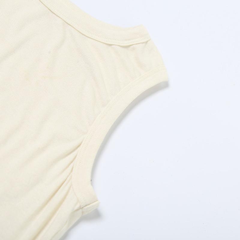Top liso sin mangas con cuello redondo, irregular y calado 